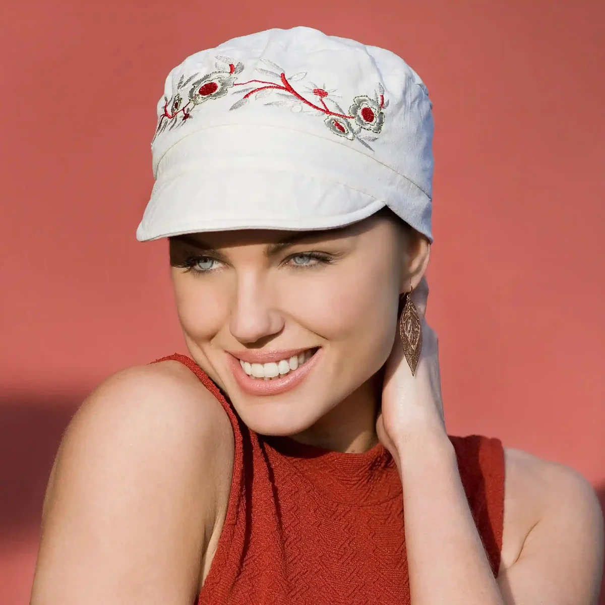 Eine Frau trägt einen weißen Chemo-Sonnenhut im Mirna-Stil.