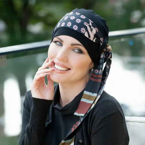 A Woman Wearing Yanna Chemo Headwear in Black Blush Fiori